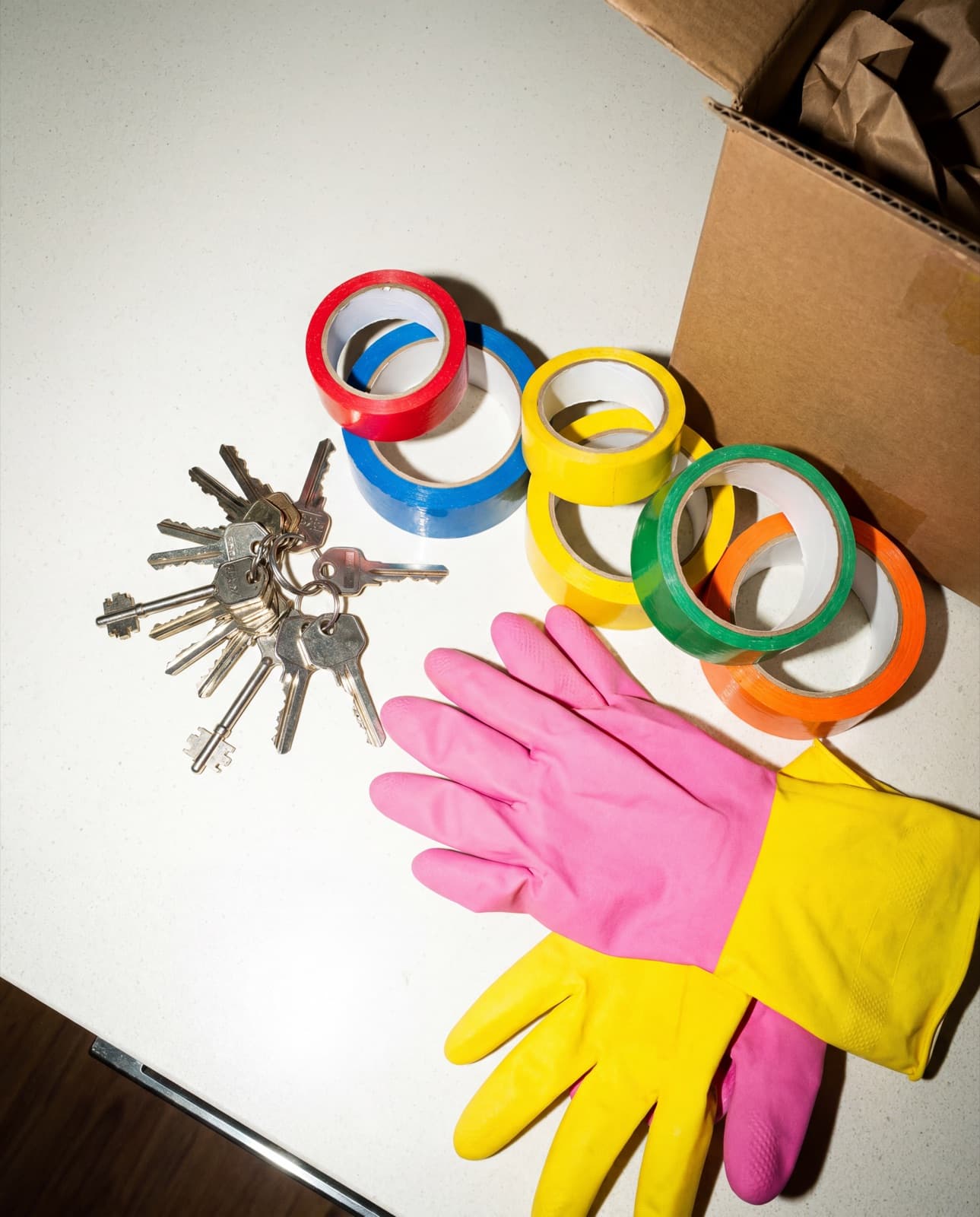 Moving day — keys and packing tape on kitchen bench